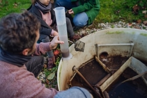 Homeowner in rural California checking water quality at access point for septic tank