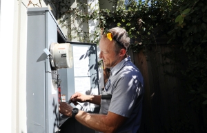 Caccia team member working on an outdoor electrical panel.