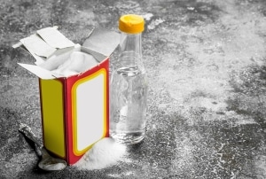 Baking soda box next to bottle of vinegar