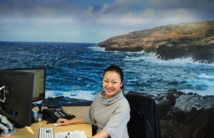 Image of Caccia employee Susan at her desk smiling and ready to help.