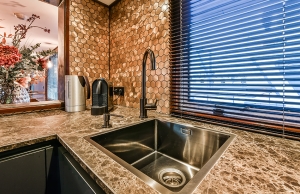 A fancy kitchen sink with a garbage disposal unit.