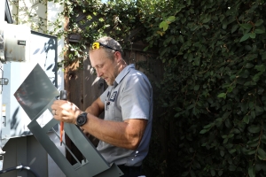 An electrician from Caccia inspecting an electrical panel before starting a panel upgrade.