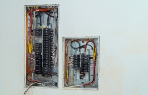 Open electrical panels on wall to represent need for upgrades