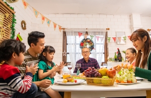 A big family enjoys a Thanksgving or Christmas meal together.