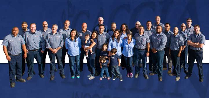 Caccia Plumbing staff standing together in blue t-shirts, on blue and white background.