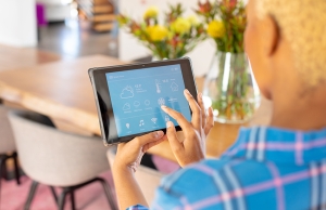 A woman controls her HVAC system and other home appliances from a convenient app.