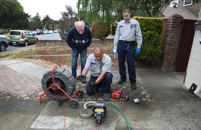 Moe and Joe snake a customer's sewer line 