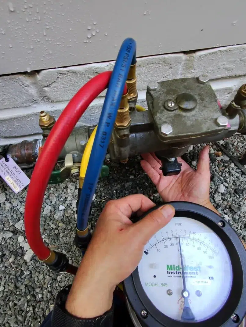 Close-up of the Midwest Model 845 differential pressure gauge showing the reading