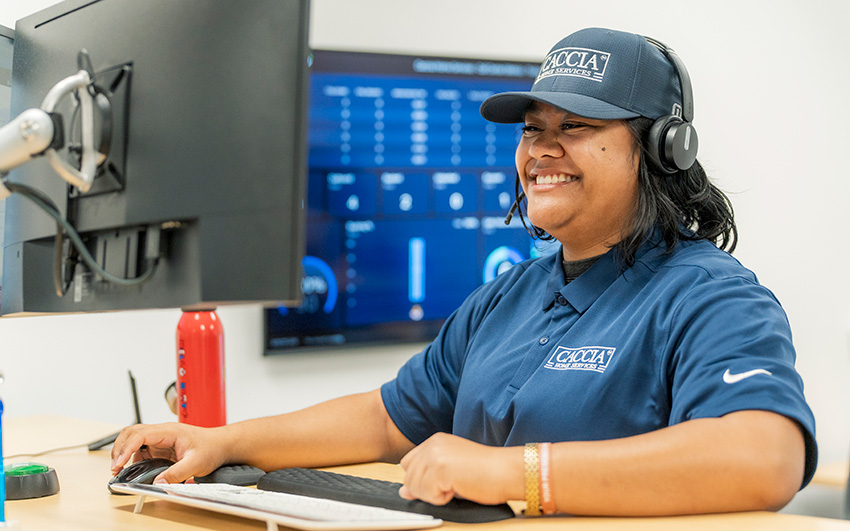 Veitoa from Caccia Home Services smiles while on a call from a customer.