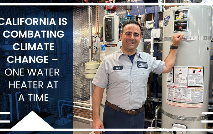 Geno Caccia smiling in front of hot water heater