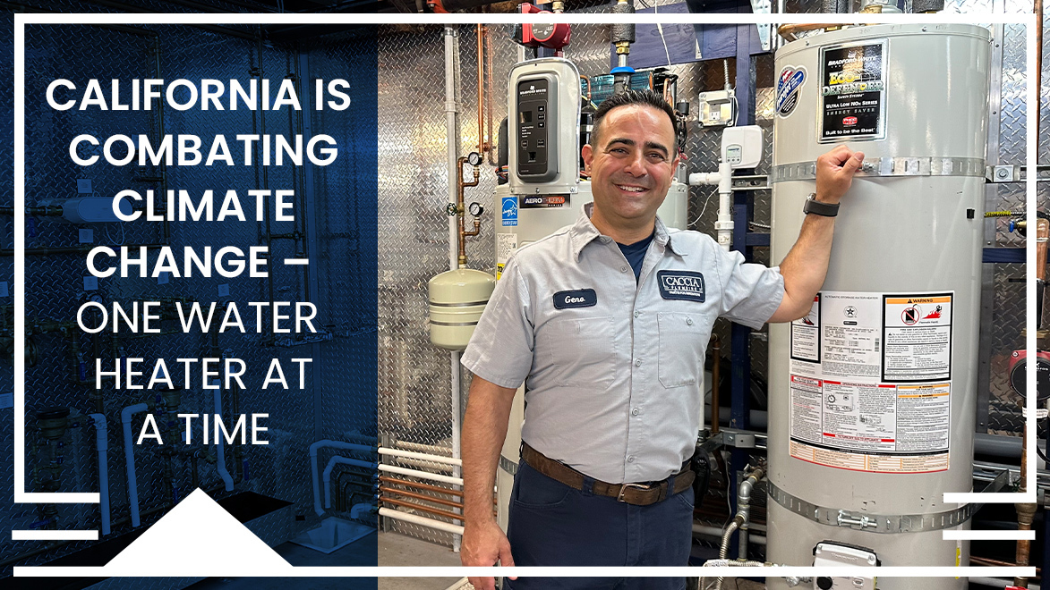 Geno Caccia smiling in front of hot water heater