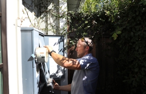 A licensed electrician from Caccia Home Services inspects a customer's electrical meter and panel.