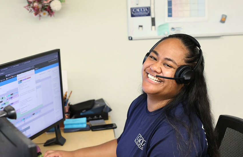 Veitoa from Caccia Home Services smiles at her desk