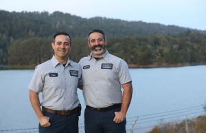 Geno and Anthony stand in front of the Pulgas Creek watershed, part of the local environment they're committed to protecting.