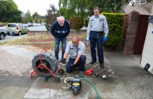 Moe and another plumber from Caccia Home Services inspect and maintain a customer's sewer line.
