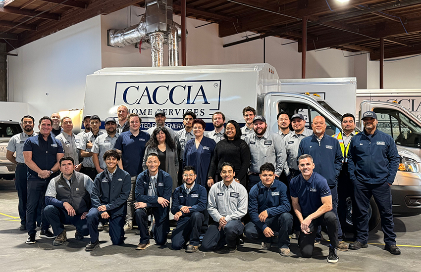 Employees at Caccia Home Services smile for a picture in front of a branded work truck