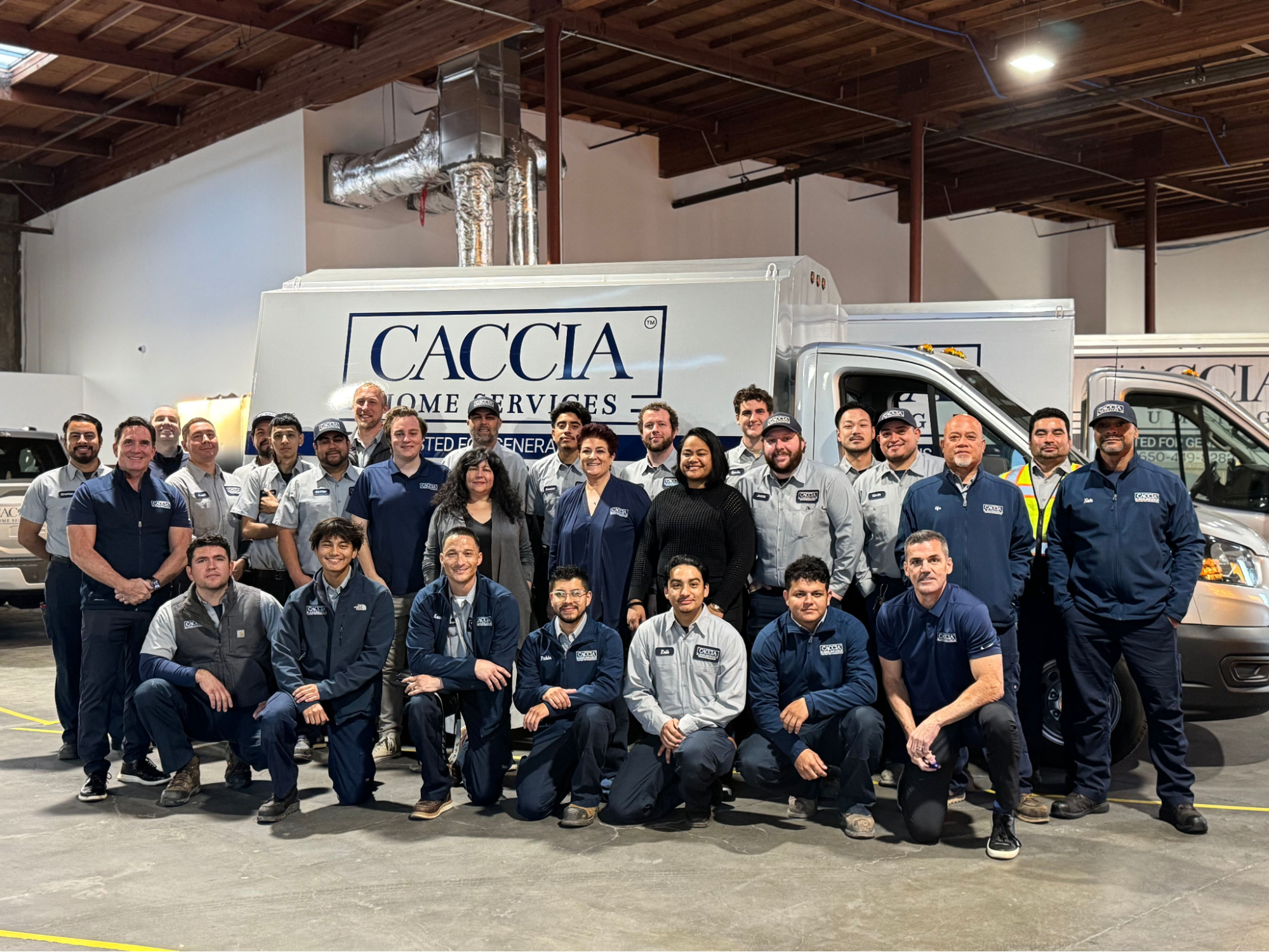 Caccia Home Service's team of employees smile for a group shot.