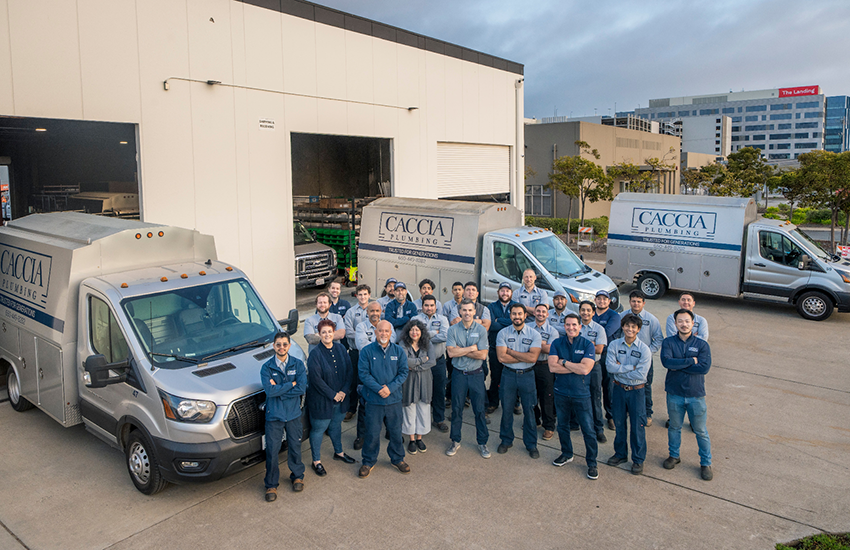 Employees from Caccia Home Services stand for a group shot in front of the main garage