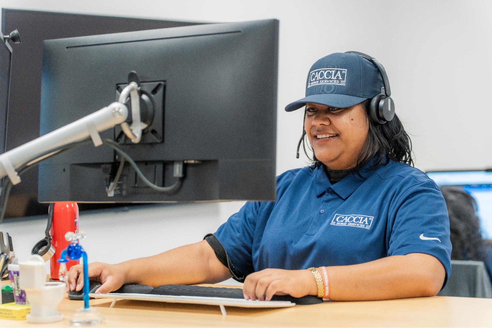 Veitoa from Caccia Home Services takes calls from customers at her desk