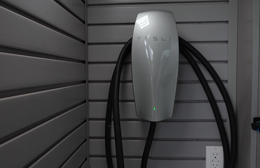 A tesla EV charger in a garage