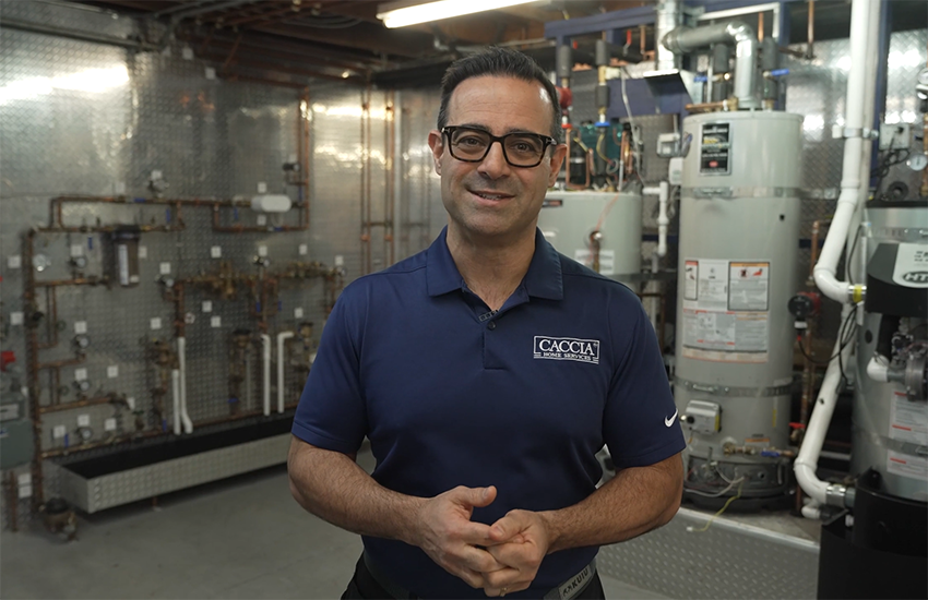 Geno stands smiling in the Caccia warehouse