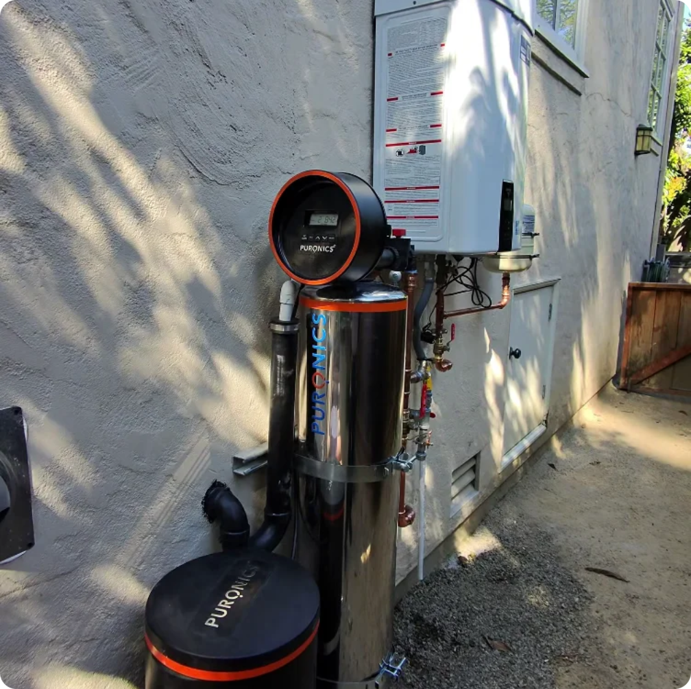Puronics water softener with its stainless media tank and dedicated brine tank