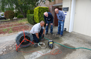 Moe from Caccia Home Services clears out a clog in a customer's sewer line.