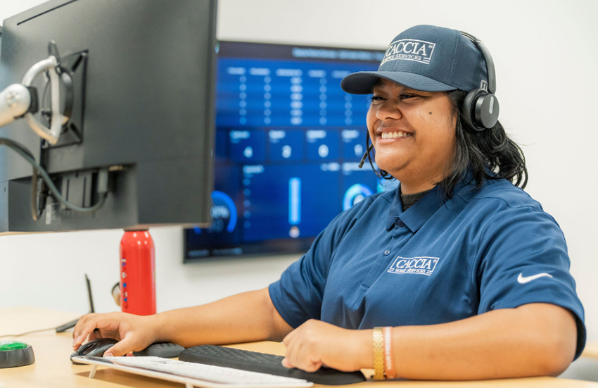 Caccia Home Services employee Veitoa smiles on a telephone call with a customer