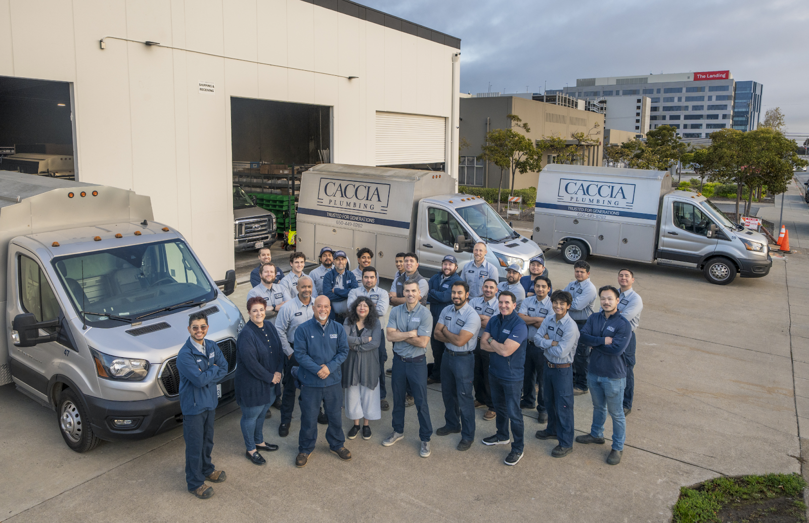 Caccia Home Services team smiling for group photo outside their shop