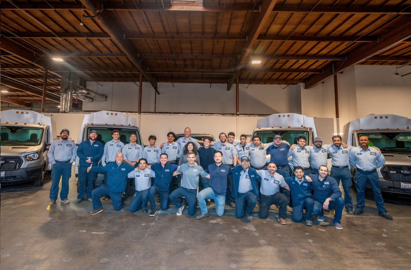 Caccia Home Services employees pose for a group shot in the loading bay